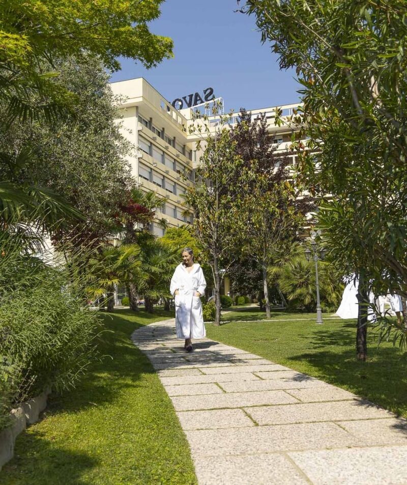 A guest strolling through the lush gardens.