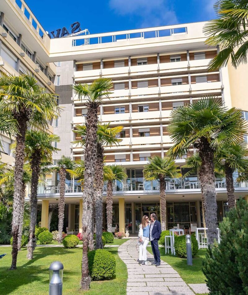 A welcoming entrance with lush palm trees.