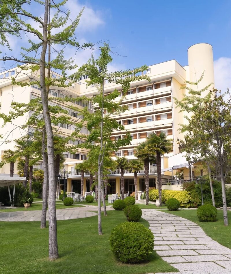 The hotel's inviting entrance with a garden.